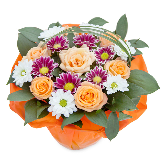 In this radiant floral bouquet, expertly crafted in Shepperton, the vivid shades and delicate interplay of blooms instantly evoke warmth and celebration. Seen from above against a pristine white backdrop, the arrangement's centerpiece is a collection of peach to orange roses unfurling with classic grace-petals soft and velvety, embodying the gentle optimism of a Shepperton morning. Surrounding them, crisp white chrysanthemum sprays with bright green centers and sophisticated magenta varieties with lime-yellow eyes add bursts of refreshing contrast, like the wildflowers you might spot on walks near Dockett Eddy Lane. Dense, glossy green leaves, perhaps ruscus, weave a lush canvas beneath, grounding the vibrancy of the blooms. Overhead, a fine loop of bear grass stretches elegantly, suggesting movement and modernity. The bouquet is swathed in radiant orange cellophane, crinkled and translucent, reflecting the spirited hues of Watersplash Road's seasonal window displays. The combination of hue, texture, and careful, artistic placement speaks to the skill of Shepperton's dedicated florists, offering a bouquet that's perfectly suited for heartfelt gifts-whether welcoming a neighbour, celebrating a birthday, or simply infusing a touch of colour and joy into everyday life.