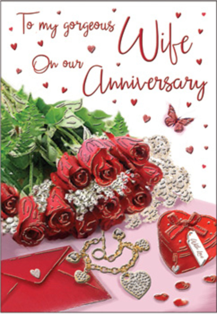 This anniversary card image unfolds like a carefully curated moment of celebration, set against a softly illuminated background that recalls a peaceful Shepperton morning. A bouquet of classic red roses dominates the scene, each blossom fully open and lush, with velvety petals layered in spirals of deep, romantic crimson. The blooms are embraced by plentiful greenery, stems and leaves arranged to feel both abundant and natural, as though a florist has just finished hand-tying them in a studio off Shepperton High Street. Around the floral focus, the card is adorned with small, sentimental treasures: a finely crafted jewellery set glints with golden warmth, and a rich red box rests close by, suggesting the anticipation of a surprise gift. Delicate heart motifs, some pressed flat and others slightly raised, scatter across the card like confetti at a small gathering with family and friends. The surface beneath everything has a subtle sheen, giving the impression of a polished table or silky cloth that reflects faint highlights from the daylight. A whisper of lace or soft fabric peeks out at the edges, adding a gentle, tactile charm. The script of the anniversary message curves across the card in elegant lettering, weaving through the design without overpowering the flowers. Together, these elements create an atmosphere of enduring romance and gratitude, the kind of love story that has weathered seasons in the same home, watched sunsets over the river, and shared countless simple joys. The overall feeling is one of warmth, reassurance, and deep connection, perfectly suited to marking another year side by side.